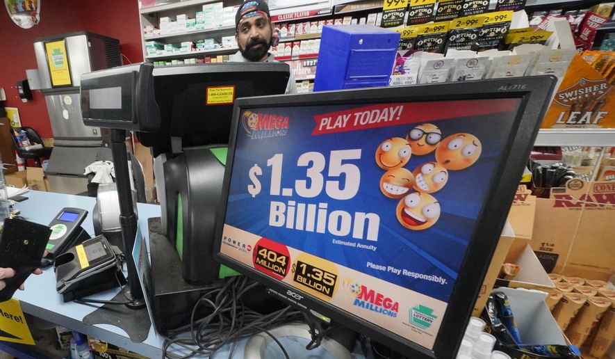 A Mega Million sign displays the estimated jackpot of $1.35 Billion at the Cranberry Super Mini Mart in Cranberry, Pa., Thursday, Jan. 12, 2023. After twenty-five consecutive drawings, with no grand prize winner named, the Mega Millions jackpot is now $1.35 billion, making it one of the largest jackpots in lottery history. (AP Photo/Gene J. Puskar)