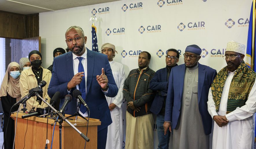 Jaylani Hussein, executive director of the Minnesota chapter of the Council on American-Islamic Relations, speaks during a news conference at CAIR-MN office, Wednesday, Jan. 11, 2023, in Minneapolis. A Hamline University lecturer showed a painting of the Prophet Muhammad and  Aram Wedatalla, left, a Hamline University senior and the president of Muslim Student Association (MSA), was one of the students in the class when the image was displayed. (Kerem Yücel/Minnesota Public Radio via AP)