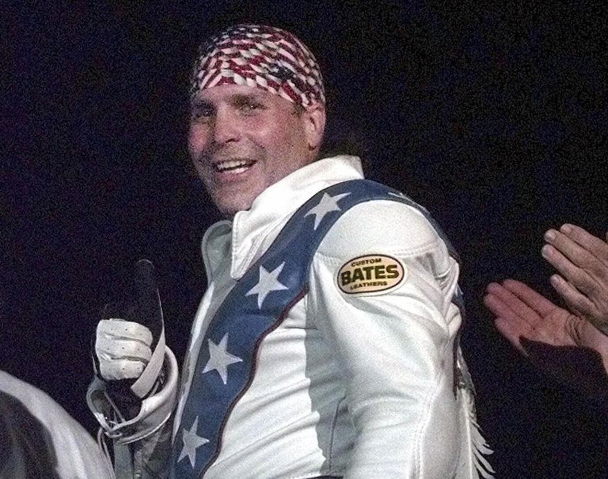 Robbie Knievel gives a thumbs up after jumping a train at the Texas State Railroad Park in Palestine, Texas on Feb. 23, 2000. Knievel, an American stunt performer, died early Friday at a hospice in Reno, Nev., with his daughters at his side, his brother Kelly Knievel said. He was 60. (AP Photo/LM Otero, File)