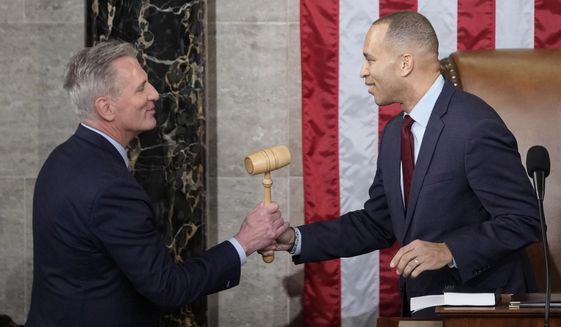 Incoming House Speaker Kevin McCarthy of Calif., receives the gavel from House Minority Leader Hakeem Jeffries of N.Y., on the House floor at the U.S. Capitol in Washington, early Saturday, Jan. 7, 2023. Republican McCarthy was elected House speaker on a historic post-midnight 15th ballot. (AP Photo/Andrew Harnik)