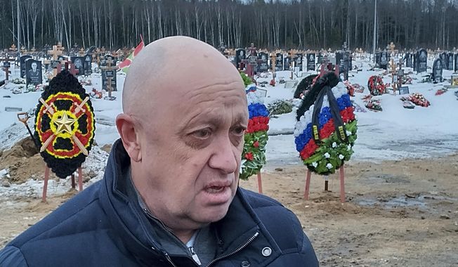 Wagner Group head Yevgeny Prigozhin attends the funeral of Dmitry Menshikov, a fighter of the Wagner group who died during a special operation in Ukraine, at the Beloostrovskoye cemetery outside St. Petersburg, Russia, Saturday, Dec. 24, 2022. The fighting for Soledar and Bakhmut again highlighted a bitter rift between the top military brass and Yevgeny Prigozhin, a rogue millionaire whose Wagner Group military contractor has played an increasing role in Ukraine. (AP Photo, File)