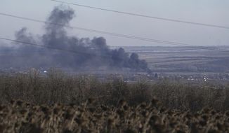 Smoke billows during fighting between Ukrainian and Russian forces in Soledar, Donetsk region, Ukraine, Wednesday, Jan. 11, 2023. Soledar and Bakhmut again highlighted a bitter rift between the top military brass and Yevgeny Prigozhin, a rogue millionaire whose Wagner Group military contractor has played an increasing role in Ukraine. (AP Photo/Libkos, File)