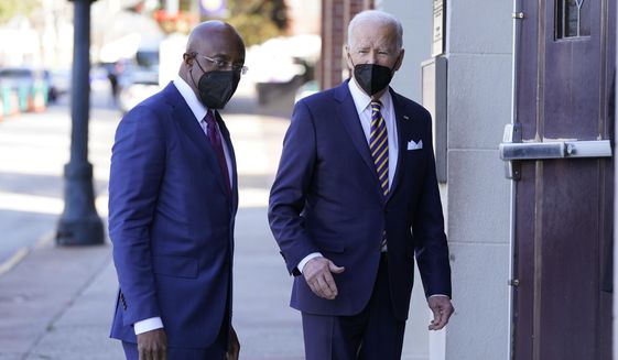 President Joe Biden and Sen. Raphael Warnock, D-Ga., enter Ebenezer Baptist Church, Jan. 11, 2022, in Atlanta. Warnock is senior pastor at the church. With Warnock having secured his first full term and Biden buoyed by Democrats&#x27; better-than-expected election results, the senator is welcoming the president back to Georgia and to America&#x27;s most famous Black church. (AP Photo/Patrick Semansky, File)