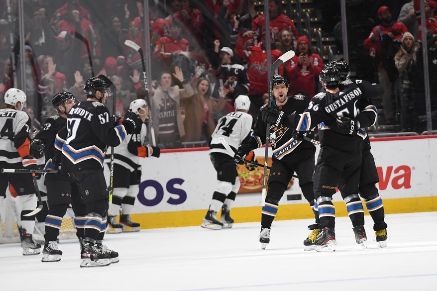 Washington Capitals players celebrate left wing Alex Ovechkin’s (8) first period goal during an NHL game against the Philadelphia Flyers at Capital One Arena in Washington D.C., January 14, 2023. (Photo by Billy Sabatini)