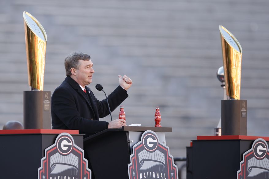 Georgia head coach Kirby Smart speaks while standing between the 2022 and 2023 championship trophies during a ceremony celebrating the Bulldog&#x27;s second consecutive NCAA college football national championship, Saturday, Jan. 14, 2023, in Athens, Ga. (AP Photo/Alex Slitz)