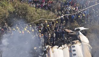 Nepalese rescue workers and civilians gather around the wreckage of a passenger plane that crashed in Pokhara, Nepal, Sunday, Jan. 15, 2023. Authorities in Nepal said 68 people have been confirmed dead after a regional passenger plane with 72 aboard crashed into a gorge while landing at a newly opened airport in the resort town of Pokhara. It&#39;s the country&#39;s deadliest airplane accident in three decades. (AP Photo/Krishna Mani Baral)