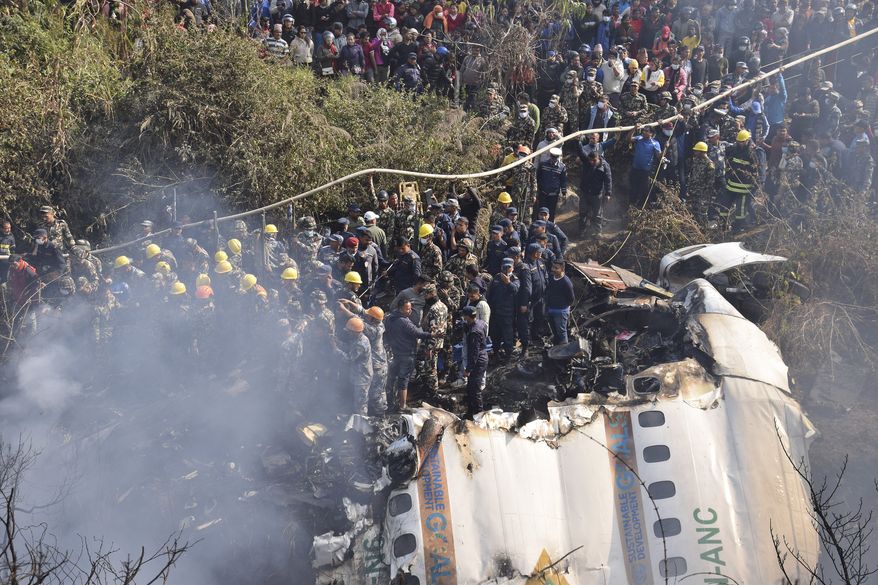 Nepalese rescue workers and civilians gather around the wreckage of a passenger plane that crashed in Pokhara, Nepal, Sunday, Jan. 15, 2023. Authorities in Nepal said 68 people have been confirmed dead after a regional passenger plane with 72 aboard crashed into a gorge while landing at a newly opened airport in the resort town of Pokhara. It&#x27;s the country&#x27;s deadliest airplane accident in three decades. (AP Photo/Krishna Mani Baral)