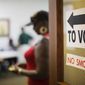 A sign directs voters at a polling site in Atlanta. (AP Photo)