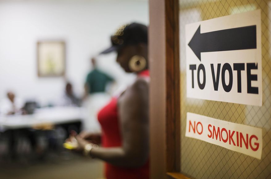 A sign directs voters at a polling site in Atlanta. (AP Photo)