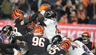 Baltimore Ravens quarterback Tyler Huntley (2) fumbles the ball as it is knocked away by Cincinnati Bengals linebacker Logan Wilson, left, in the second half of an NFL wild-card playoff football game in Cincinnati, Sunday, Jan. 15, 2023. The Bengals&#39; Sam Hubbard recovered the fumble and ran it back for a touchdown. ( (AP Photo/Darron Cummings) **FILE**