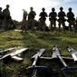 FILE - Weapons lie on the ground as Ukrainian personnel take a break during training at a military base with UK Armed Forces in Southern England on Oct. 12, 2022. The U.S. military&#39;s new, expanded combat training of Ukrainian forces began in Germany on Sunday, Jan. 15, 2023, with a goal of getting a battalion of about 500 troops back on the battlefield to fight the Russians in the next five to eight weeks, said Gen. Mark Milley, chairman of the Joint Chiefs of Staff. (AP Photo/Kirsty Wigglesworth, File)
