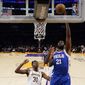 Philadelphia 76ers center Joel Embiid (21) shoots against Los Angeles Lakers center Thomas Bryant (31) during the first half of an NBA basketball game in Los Angeles, Sunday, Jan. 15, 2023. (AP Photo/Ashley Landis)