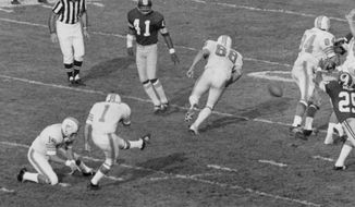 A field goal attempt by Garo Yepremian (1) of the Miami Dolphins is blocked by the Washington Redskins in the Super Bowl game in Los Angeles, Jan. 14, 1973. Yepremian&#x27;s blocked field goal turned into perhaps the worst try at a pass in NFL history. Washington&#x27;s Mike Bass grabbed it and headed to the end zone for a 49-yard touchdown that was his side&#x27;s only score in the 14-7 defeat.(AP Photo/File) **FILE**