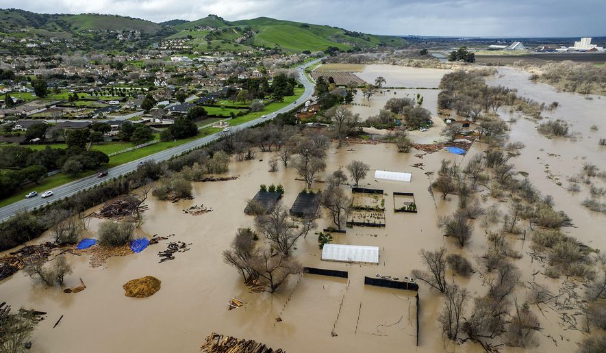 Floodwater covers a property along River Road in Monterey County, Calif., as the Salinas River overflows its banks on Friday, Jan. 13, 2023. (AP Photo/Noah Berger)