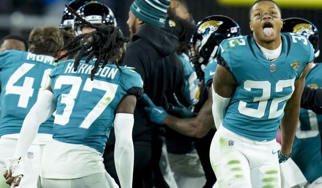 The Jacksonville Jaguars celebrate his game-winning field goal against the Los Angeles Chargers during the second of an NFL wild-card football game, Saturday, Jan. 14, 2023, in Jacksonville, Fla. Jacksonville Jaguars won 31-30. (AP Photo/John Raoux)