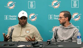 Miami Dolphins general manager Chris Grier, left, and head coach Mike McDaniel, right, respond to questions during a news conference at the NFL football team&#39;s training facility, Monday, Jan. 16, 2023, in Miami Gardens, Fla. (AP Photo/Lynne Sladky)