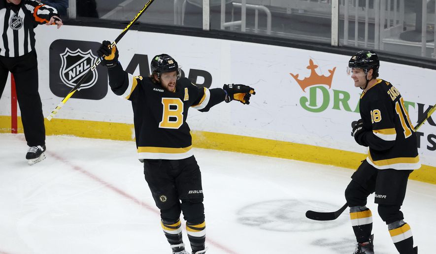 Boston Bruins right wing David Pastrnak celebrates with teammate Pavel Zacha (18) after scoring a goal during the first period of an NHL hockey game against the Philadelphia Flyers, Monday, Jan. 16, 2023, in Boston. (AP Photo/Mary Schwalm) **FILE**