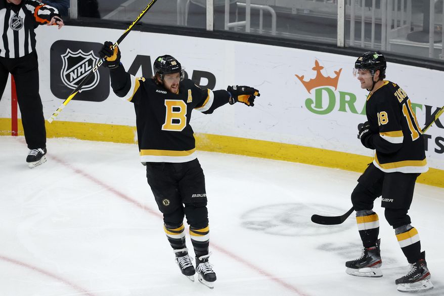 Boston Bruins right wing David Pastrnak celebrates with teammate Pavel Zacha (18) after scoring a goal during the first period of an NHL hockey game against the Philadelphia Flyers, Monday, Jan. 16, 2023, in Boston. (AP Photo/Mary Schwalm) **FILE**