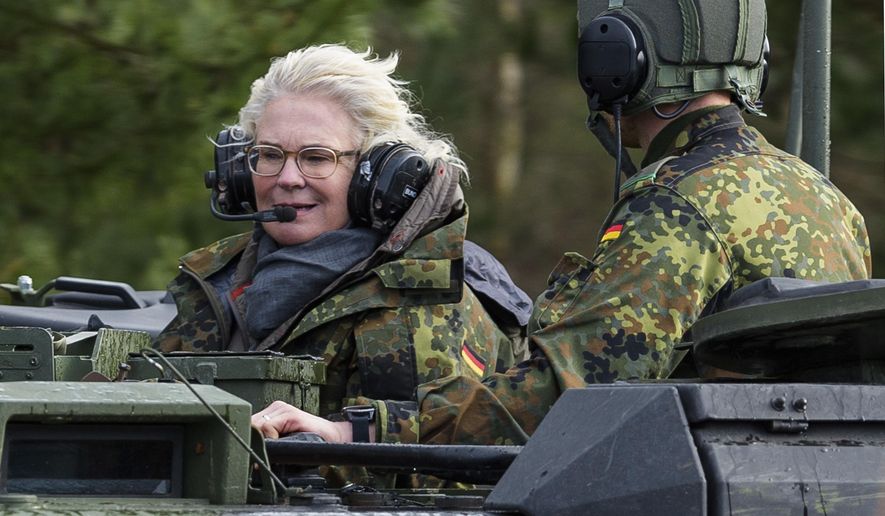 Christine Lambrecht, former Minister of Defense, rides in a tank during her visit to the Tank Training Brigade 9 in Munster, Germany, Feb. 7, 2022. Defense Minister Christine Lambrecht resigns. She has asked Chancellor Olaf Scholz to dismiss her, said a statement from the minister on Monday. (Philipp Schulze/dpa via AP, File)