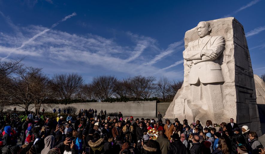 A large group gathers to watch a wreath-laying ceremony at the Martin Luther King Jr. Memorial on Martin Luther King Jr. Day in Washington, Monday, Jan. 16, 2023. (AP Photo/Andrew Harnik)