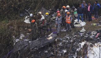 Rescuers scour the crash site in the wreckage of a passenger plane in Pokhara, Nepal, Monday, Jan.16, 2023. Nepal began a national day of mourning Monday as rescue workers resumed the search for six missing people a day after a plane to a tourist town crashed into a gorge while attempting to land at a newly opened airport, killing at least 66 of the 72 people aboard in the country&#39;s deadliest airplane accident in three decades.(AP Photo/Yunish Gurung)