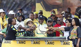 African National Congress (ANC) President Cyril Ramaphosa cuts a cake with supporters at the Dr Molemela stadium in Mangaung, South Africa, Sunday, Jan 8, 2023. The ANC marks its 111st anniversary with celebratory events in Mangaung, Free State province, where the organization was founded in 1912. (AP Photo)