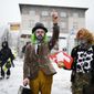 Two man made up as clowns attend a demonstration against the annual meeting of the World Economic Forum in Davos, Switzerland, Sunday, Jan. 15, 2023. The annual meeting of the World Economic Forum is taking place in Davos from Jan. 16 until Jan. 20, 2023. (AP Photo/Markus Schreiber)