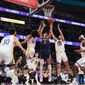 Washington Wizards forward Deni Avdija (9) goes up for a rebound against Golden State Warriors forward Anthony Lamb (40) and guard Ty Jerome (10) during the first half of an NBA basketball game, Monday, Jan. 16, 2023, in Washington. (AP Photo/Jess Rapfogel)