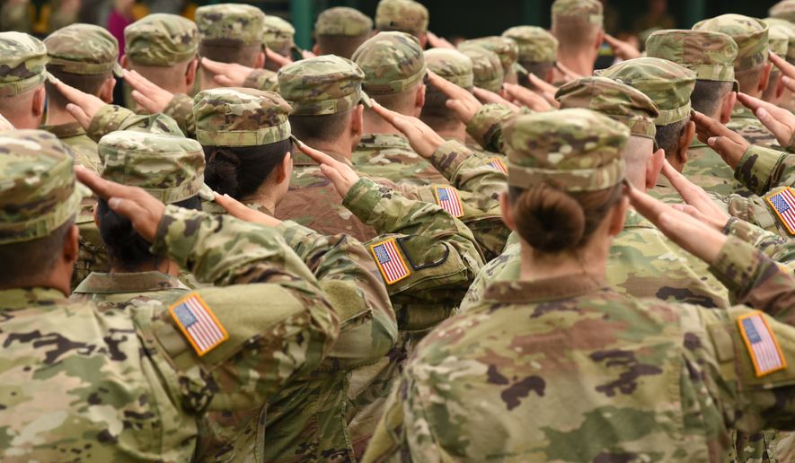 U.S. soldiers giving a salute. File photo credit: Bumble Dee via Shutterstock
