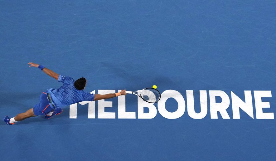 Novak Djokovic of Serbia plays a forehand return to Roberto Carballes Baena of Spain during their first round match at the Australian Open tennis championship in Melbourne, Australia, Tuesday, Jan. 17, 2023. (AP Photo/Aaron Favila)