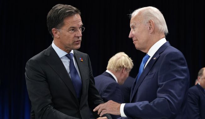Netherland&#x27;s Prime Minister Mark Rutte, left, speaks with U.S. President Joe Biden during a round table meeting at a NATO summit in Madrid, Spain, June 29, 2022. Biden is set to host Rutte for talks. The U.S. administration is looking to persuade the Netherlands to further limit China&#x27;s access to advanced semiconductors with export restrictions. (AP Photo/Susan Walsh, Pool)