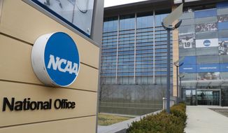 This is a March 12, 2020, file photo showing NCAA headquarters in Indianapolis. The NCAA and many of its student-athletes are closely watching a court case in Pennsylvania that could determine whether Division I athletes should be paid for their time in the same way students are paid for work-study jobs. (AP Photo/Michael Conroy, File) **FILE**