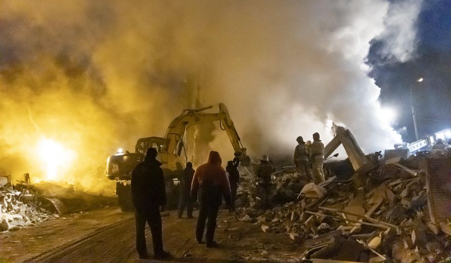 Smoke rises as Donetsk&#x27;s emergency employees work at a site of a shopping center destroyed following what Russian officials in Donetsk said it was a shelling by Ukrainian forces, in Donetsk, in Russian-controlled Donetsk region, eastern Ukraine, Monday, Jan. 16, 2023. (AP Photo/Alexei Alexandrov)