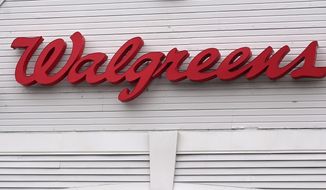 The Walgreens logo on the front of a store, July 14, 2021, in Cambridge, Mass. A huge opioid settlement dragged Walgreens to a $3.7 billion loss in its fiscal first quarter, but the drugstore chain still beat Wall Street forecasts. The company also reaffirmed its earnings forecast for the new year. Walgreens said Thursday, Jan. 5, 2023 that it recorded a $5.2-billion, after-tax charge in the quarter that ended November 30 for opioid-related litigation. (AP Photo/Charles Krupa, File)
