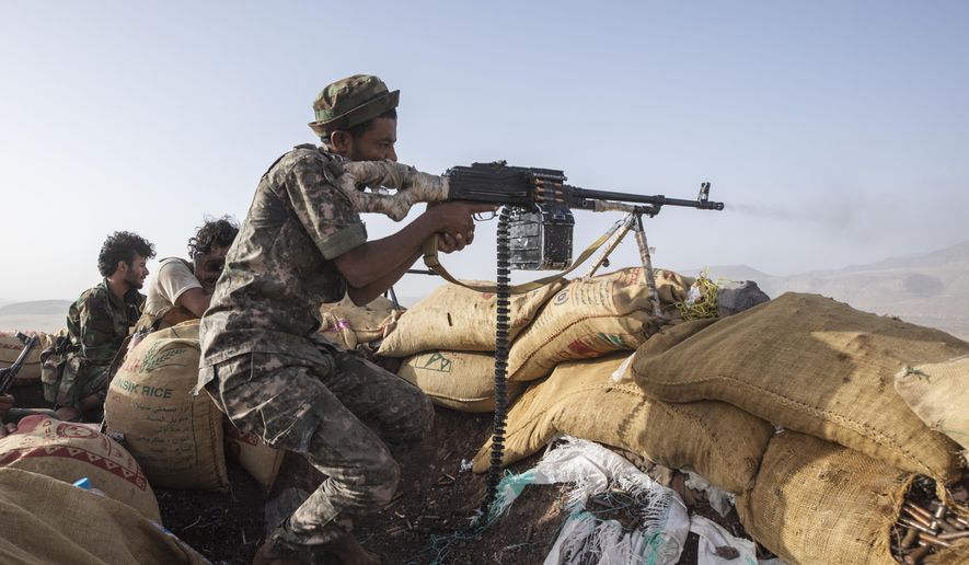 A Yemeni fighter backed by the Saudi-led coalition fires his weapon during clashes with Houthi rebels on the Kassara frontline near Marib, Yemen, June 20, 2021. (AP Photo/Nariman El-Mofty, File)