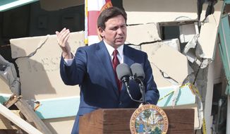 Florida Gov. Ron DeSantis speaks to the crowd gathered on the beach ramp, Wednesday Jan. 18, 2023 during a presser where he presented Volusia County officials with a multi million dollar check for beach erosion projects. (David Tucker/The Daytona Beach News-Journal via AP)