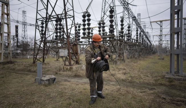 A worker at a power plant, tries to repair damages after a Russian attack in central Ukraine, Jan. 5, 2023. The Biden administration will provide $125 million for parts and other supplies to help repair crews in Ukraine keep up with Russian strikes pounding the country’s electrical system. U.S. international development aid chief Samantha Power announced the funding in a statement Wednesday. (AP Photo/Evgeniy Maloletka, File)