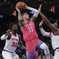 Washington Wizards forward Kyle Kuzma (33) goes to the basket against New York Knicks forward Julius Randle (30) and guard RJ Barrett during the second half of an NBA basketball game Wednesday, Jan. 18, 2023, at Madison Square Garden in New York. The Wizards won 116-105. (AP Photo/Mary Altaffer)