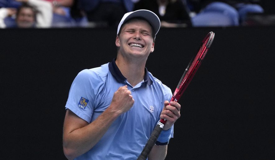 Jenson Brooksby of the U.S. celebrates after defeating Casper Ruud of Norway in their second round match at the Australian Open tennis championship in Melbourne, Australia, Thursday, Jan. 19, 2023. (AP Photo/Dita Alangkara)