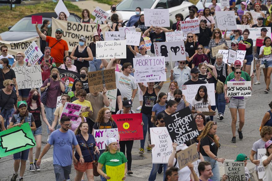 Pro-choice protestors march between the Indiana Statehouse and the Indiana State Library where Vice President Kamala Harris was meeting with Indiana legislators to discuss reproductive rights in Indianapolis on July 25, 2022. The fate of Indiana’s Republican-backed abortion ban goes Thursday, Jan. 19, 2023, before the state Supreme Court as it hears arguments on whether it violates privacy protections under the state constitution. (AP Photo/Michael Conroy, File)