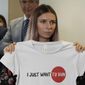 Belarusian Olympic sprinter Krystsina Tsimanouskaya, who arrived in Poland fearing reprisals at home after criticizing her coaches at the Tokyo Games, holds up an Olympic-related T-shirt with the slogan &quot;I Just Want to Run&quot; after her news conference in Warsaw, Poland, Thursday, Aug. 5, 2021. The Belarusian track coach who tried to force the sprinter out of the Tokyo Olympics and back to Belarus after she was critical of the team has been charged with breaching the sport&#39;s integrity standards. The Athletics Integrity Unit announced the charges against Yury Maisevich on Thursday, Jan. 19, 2023. (AP Photo/Czarek Sokolowski, File)