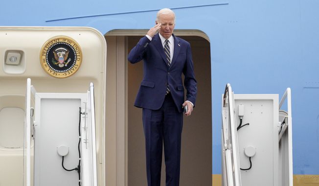 President Joe Biden returns a salute as he boards Air Force One at Andrews Air Force Base, Md., Thursday, Jan. 19, 2023, en route to California. (AP Photo/Jess Rapfogel)