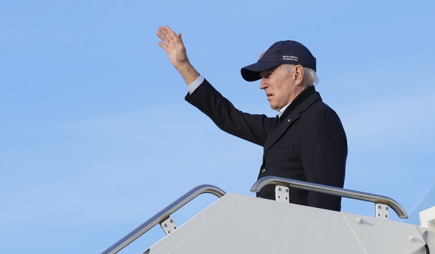President Joe Biden waves as he boards Air Force One at Moffett Federal Airfield in Mountain View, Calif., after touring storm damage Thursday, Jan 19, 2023. (AP Photo/Susan Walsh)