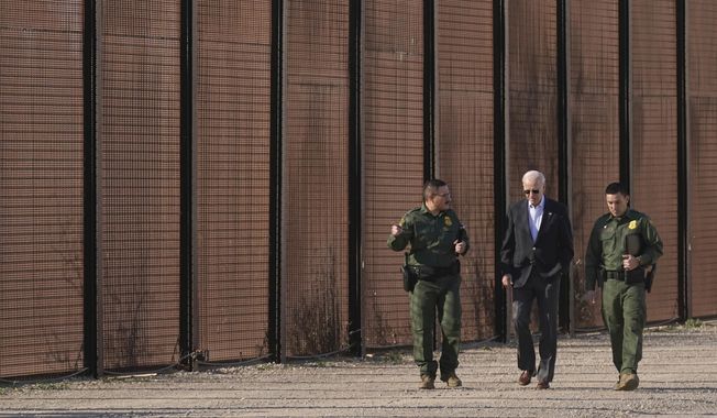 President Joe Biden walks with U.S. Border Patrol agents along a stretch of the U.S.-Mexico border in El Paso Texas, on Sunday, Jan. 8, 2023. For the 12 months ending Sept. 30, 2022, U.S. Customs and Border Protection reported it stopped migrants at the U.S. border nearly 2.4 million times, a record surge driven by sharp increases in Venezuelans, Cubans and Nicaraguans making the trek. (AP Photo/Andrew Harnik) **FILE**