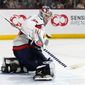 Washington Capitals goaltender Darcy Kuemper makes a save against the Arizona Coyotes during the first period of an NHL hockey game in Tempe, Ariz., Thursday, Jan. 19, 2023. (AP Photo/Ross D. Franklin)