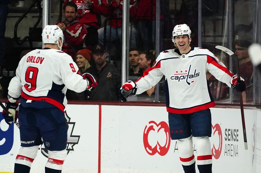 Washington Capitals center Dylan Strome smiles as he celebrates his goal against the Arizona Coyotes with defenseman Dmitry Orlov (9) during the first period of an NHL hockey game in Tempe, Ariz., Thursday, Jan. 19, 2023. (AP Photo/Ross D. Franklin)