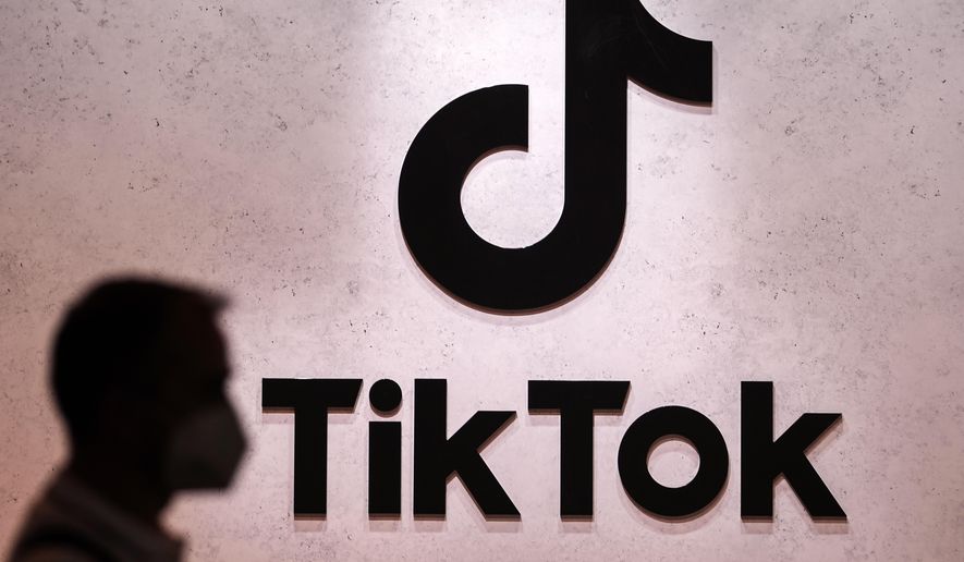 A visitor passes the TikTok exhibition stands at the Gamescom computer gaming fair in Cologne, Germany, Aug. 25, 2022. The European Union&#x27;s digital policy chief warned TikTok&#x27;s boss Thursday, Jan. 19, 2023 that the social media app will have to fall in line with tough new rules for online platforms set to take effect later this year. EU Commissioner Thierry Breton held a video call with Shou Zi Chew, the CEO of TikTok, the popular Chinese-owned video sharing app that&#x27;s coming under increasing scrutiny from Western authorities over fears about data privacy, cybersecurity and misinformation. (AP Photo/Martin Meissner, File)