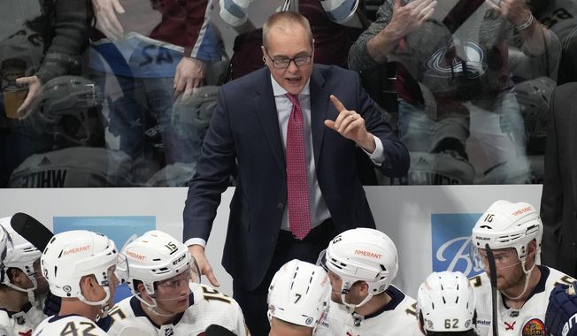 Florida Panthers coach Paul Maurice talks to players during the third period of the team&#x27;s NHL hockey game against the Colorado Avalanche on Tuesday, Jan. 10, 2023, in Denver. (AP Photo/David Zalubowski)