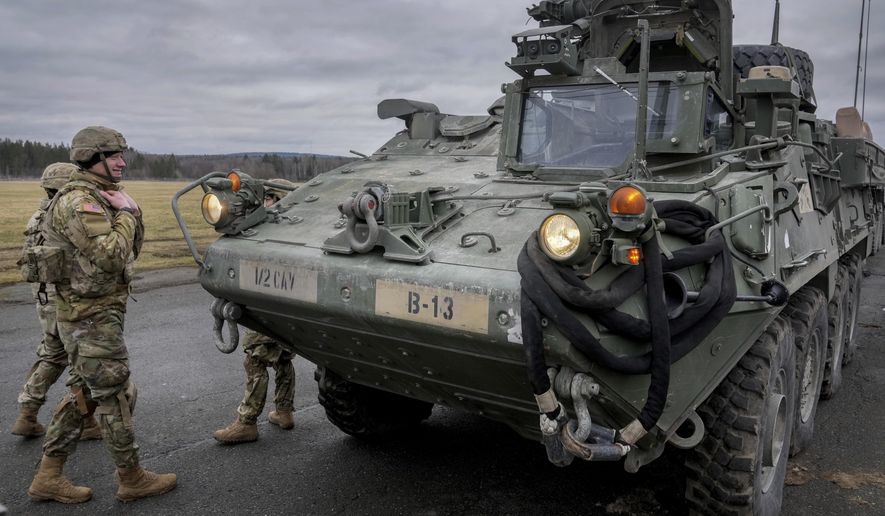 Soldiers of the 2nd Cavalry Regiment stand next to a Stryker combat vehicle in Vilseck, Germany, Wednesday, Feb. 9, 2022. The U.S. is finalizing a massive package of military aid for Ukraine that U.S. officials say is likely to total as much as $2.6 billion. It&#x27;s expected to include for the first time nearly 100 Stryker combat vehicles and at least 50 Bradley fighting vehicles to allow Ukrainian forces to move more quickly and security on the front lines. (AP Photo/Michael Probst, File)