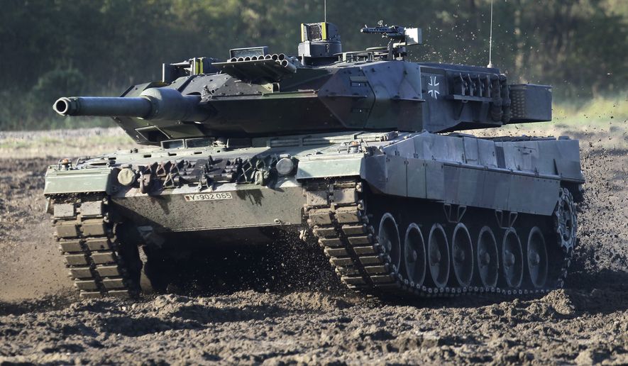 A Leopard 2 tank is pictured during a demonstration event held for the media by the German Bundeswehr in Munster near Hannover, Germany, Wednesday, Sept. 28, 2011. Germany faces mounting pressure to supply battle tanks to Kyiv and Ukrainian President Volodymyr Zelenskyy is airing frustration about not obtaining enough weaponry as Western allies confer on how best to support Ukraine nearly 11 months into Russia’s invasion. Germany’s new defense minister welcomed U.S. Defense Secretary Lloyd Austin to Berlin, declaring that German weapons systems delivered so far have proven their worth and that aid will continue in the future. (AP Photo/Michael Sohn) **FILE**